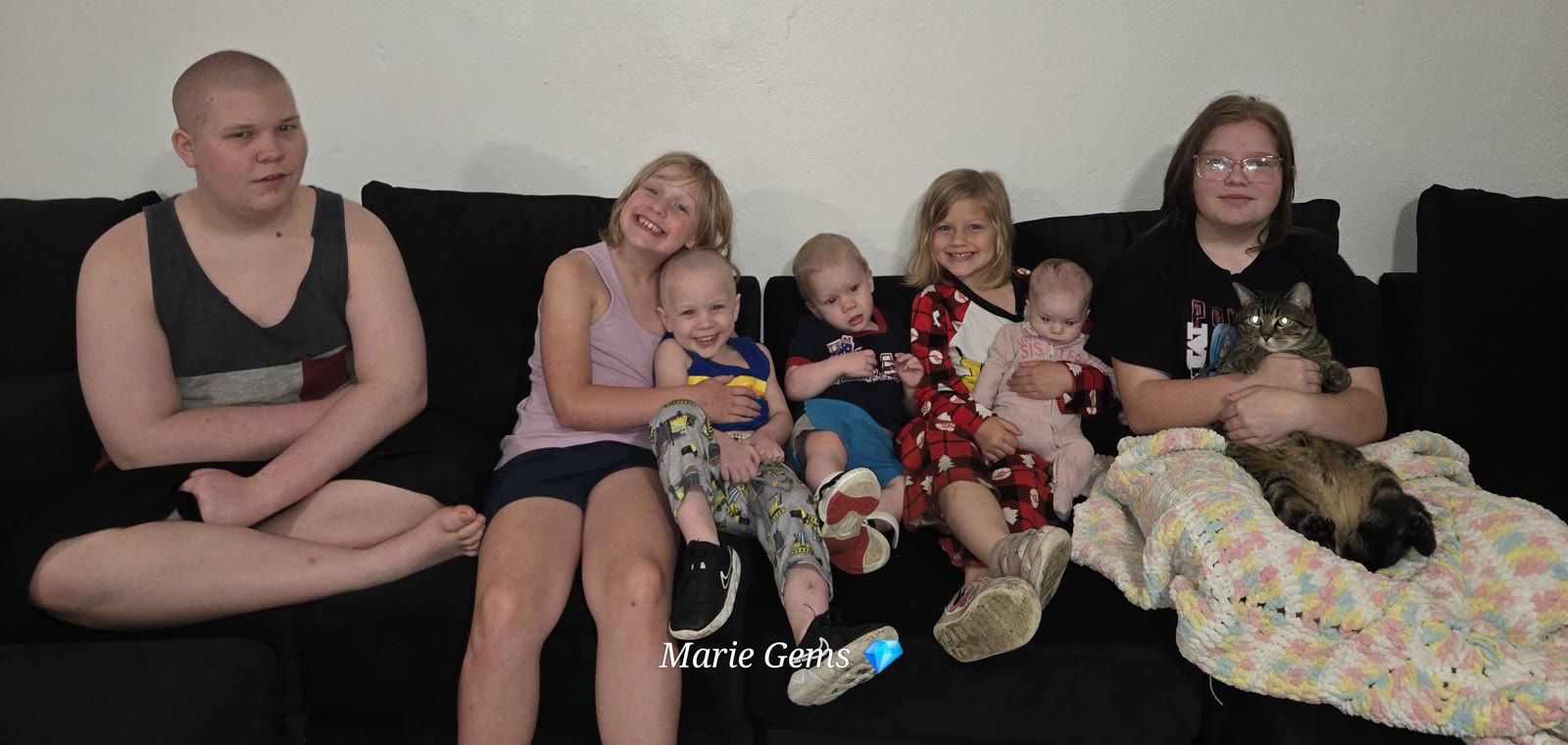 Marie Harvey with her seven kids on the couch